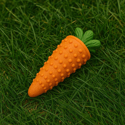 Carrot-shaped dog toy with textured surface on grass