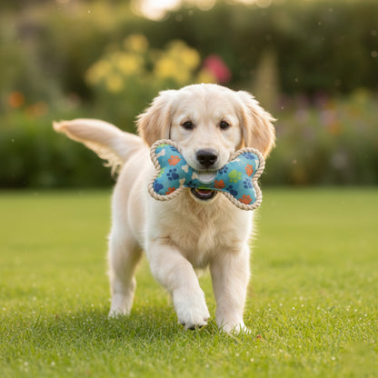 Dog running on grass with a colorful bone-shaped toy in its mouth