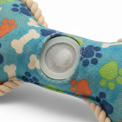 Dog toy with colorful paw and bone patterns on a blue background